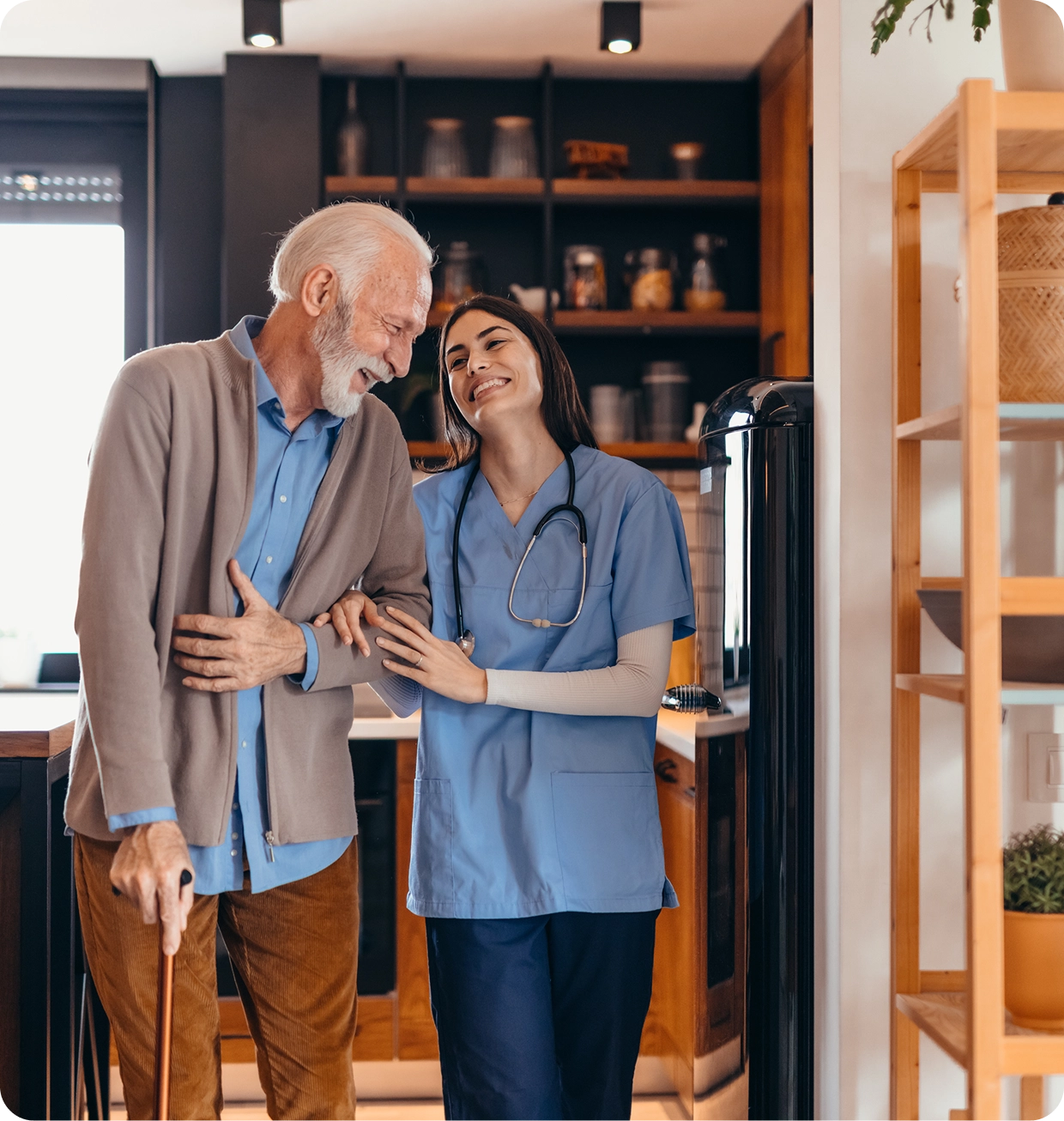 Elderly man with nurse in modern kitchen.